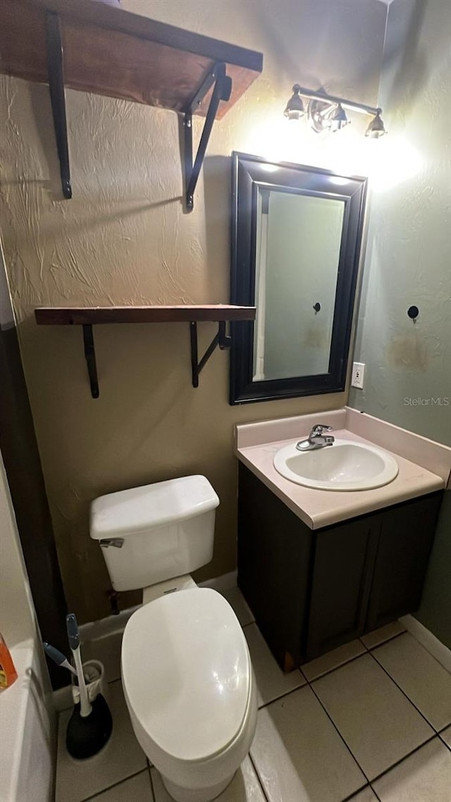 bathroom with vanity, tile patterned floors, and toilet