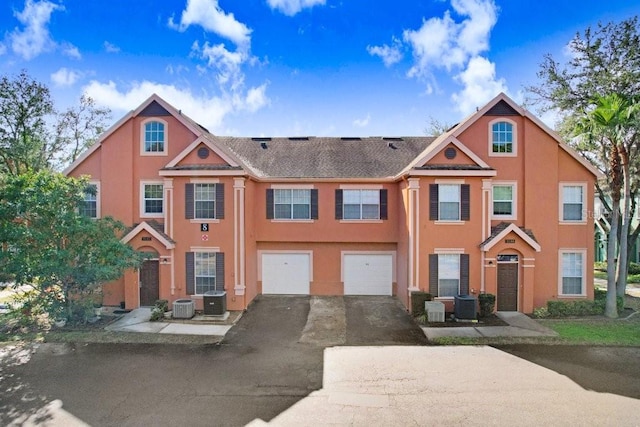 view of front of property featuring a garage and central AC unit