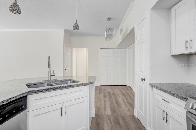 kitchen featuring pendant lighting, dishwasher, sink, and white cabinets