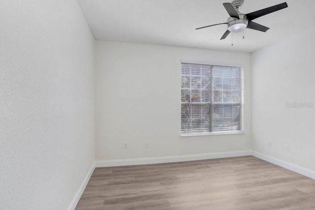 empty room featuring light hardwood / wood-style flooring and ceiling fan