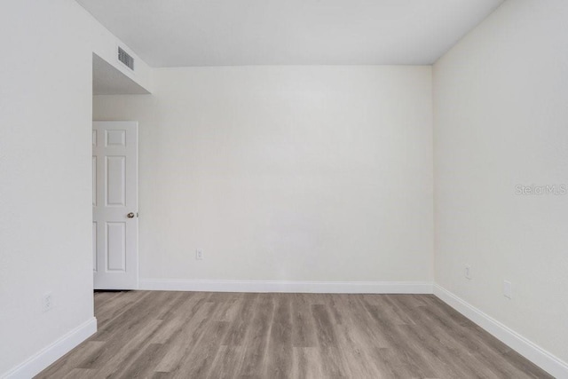 unfurnished room with light wood-type flooring