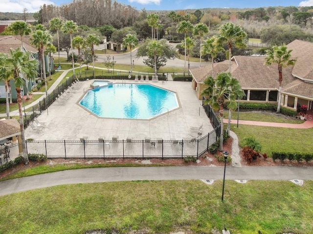 view of pool with a patio area and a lawn