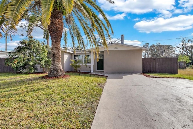 ranch-style home with a front lawn