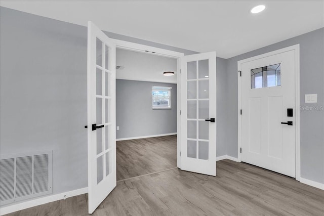 entryway featuring french doors and light wood-type flooring