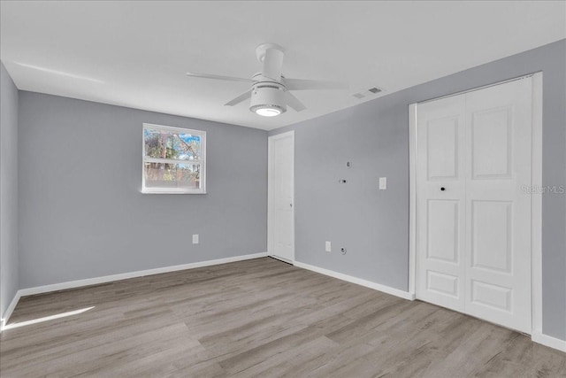 spare room with ceiling fan and light hardwood / wood-style floors