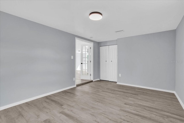 unfurnished room with light wood-type flooring