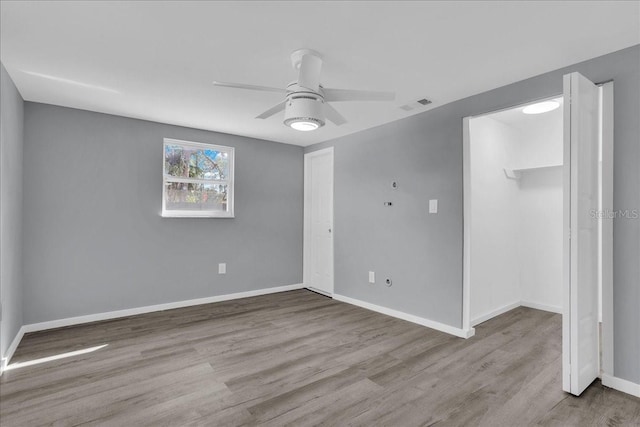 empty room featuring ceiling fan and light hardwood / wood-style floors