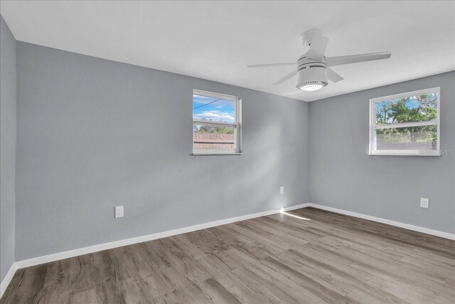 empty room with light hardwood / wood-style floors and ceiling fan