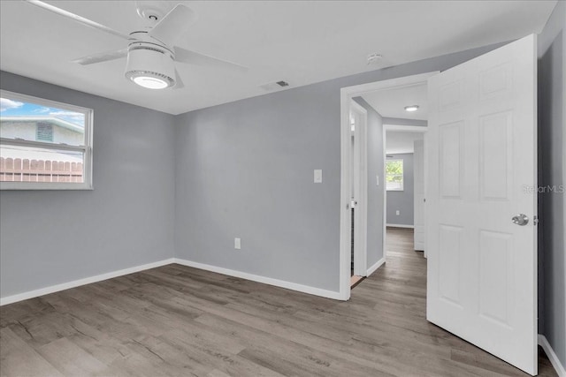 empty room featuring ceiling fan and light hardwood / wood-style floors