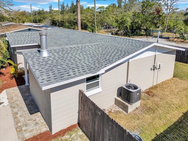 view of side of home with central AC unit