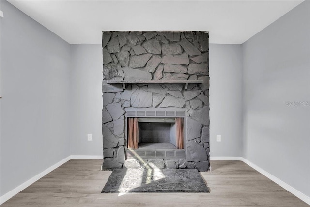 room details featuring hardwood / wood-style flooring and a fireplace