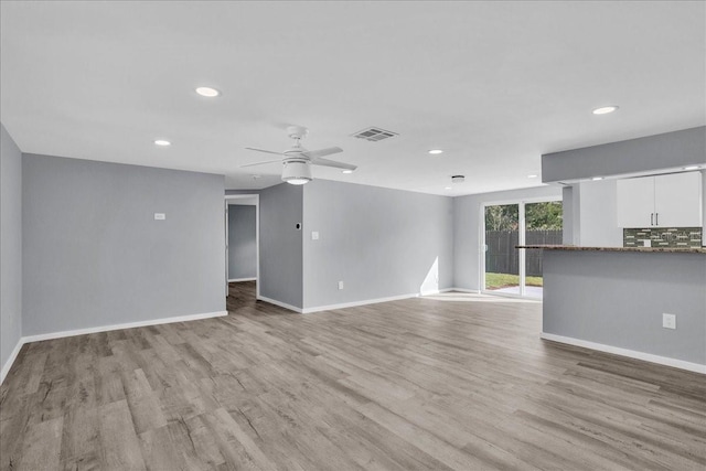 unfurnished living room featuring light hardwood / wood-style floors and ceiling fan