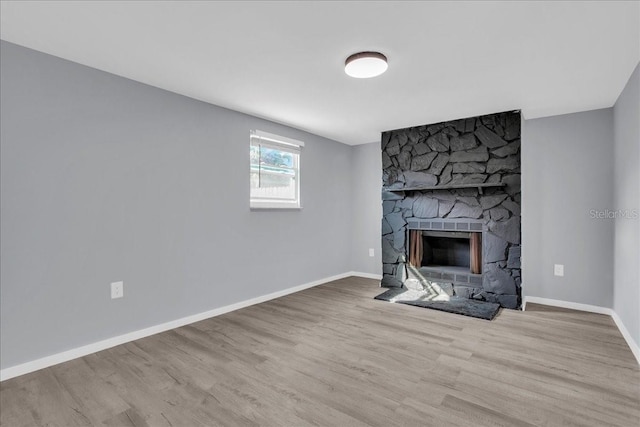 unfurnished living room with a fireplace and light hardwood / wood-style flooring