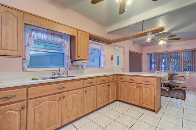 kitchen with sink, light tile patterned floors, plenty of natural light, and kitchen peninsula