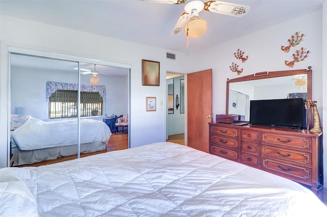 bedroom with ceiling fan and a closet