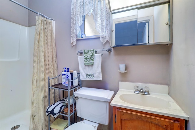 bathroom featuring vanity, curtained shower, and toilet