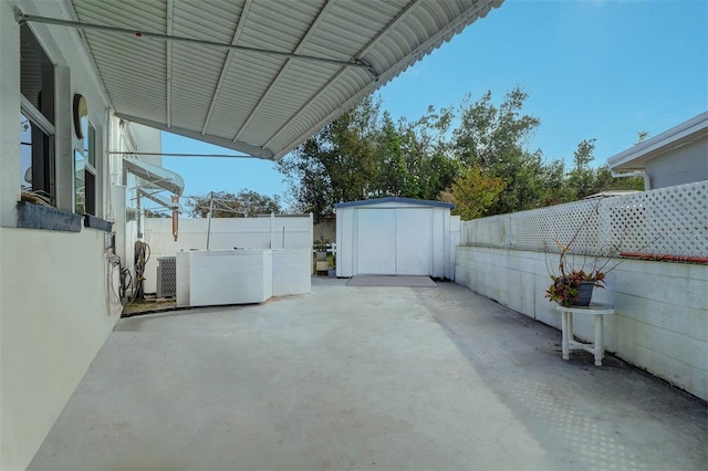 view of patio / terrace featuring central AC and a storage shed