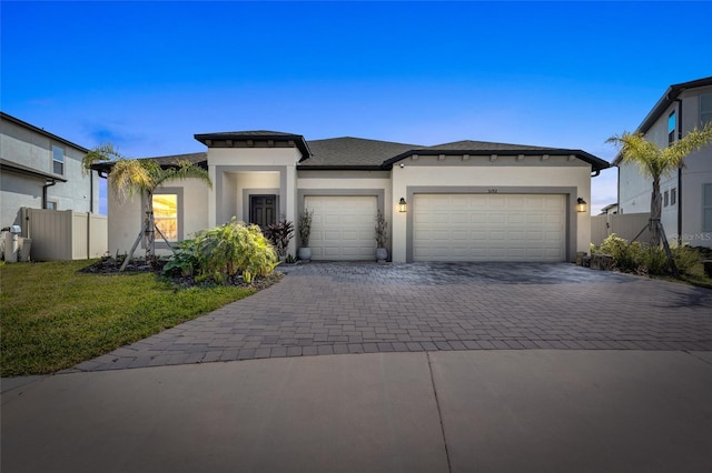 view of front facade featuring a garage and a front lawn