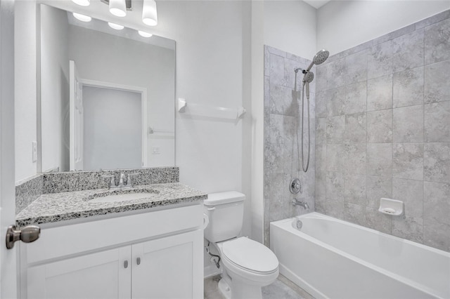 full bathroom featuring tiled shower / bath combo, vanity, and toilet