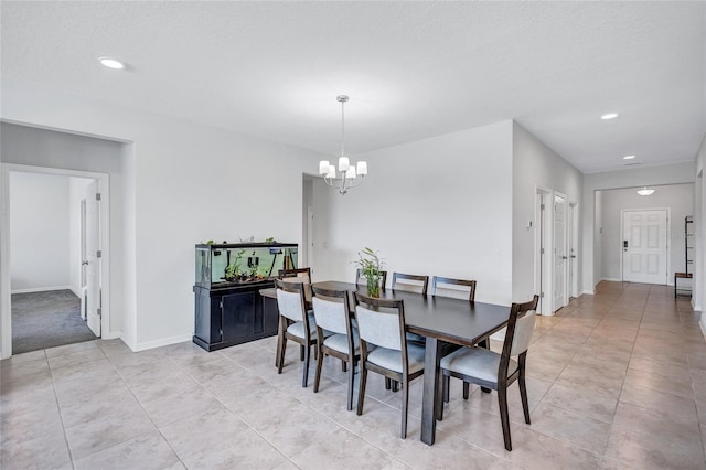 tiled dining room featuring a notable chandelier