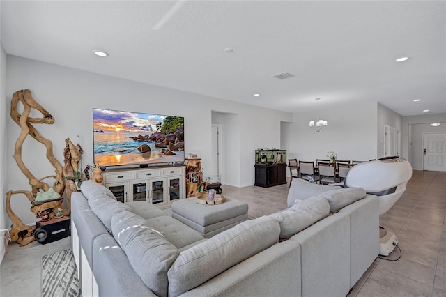 living room with light tile patterned flooring and a notable chandelier