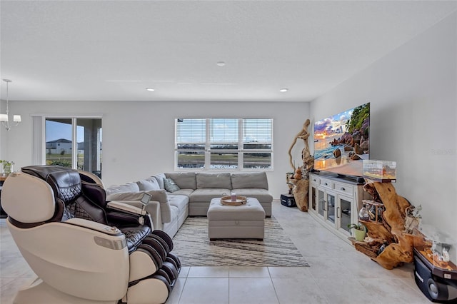 living room featuring a notable chandelier, light tile patterned floors, and a wealth of natural light