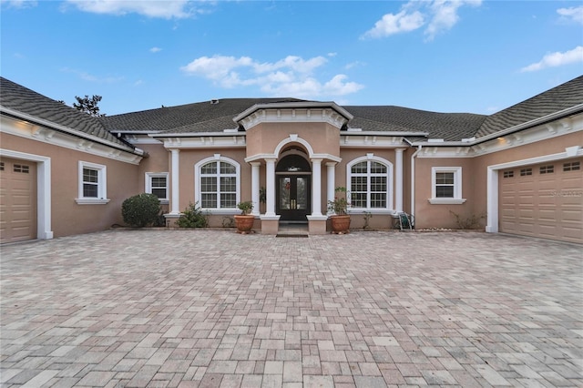 view of front of property featuring a garage and french doors