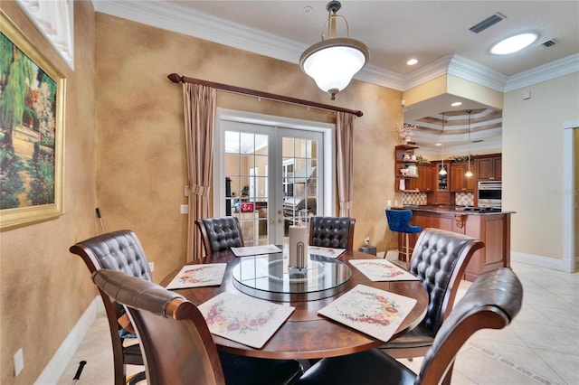 tiled dining space with french doors and crown molding