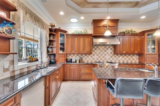 kitchen with wall chimney exhaust hood, a kitchen bar, hanging light fixtures, dishwashing machine, and dark stone counters