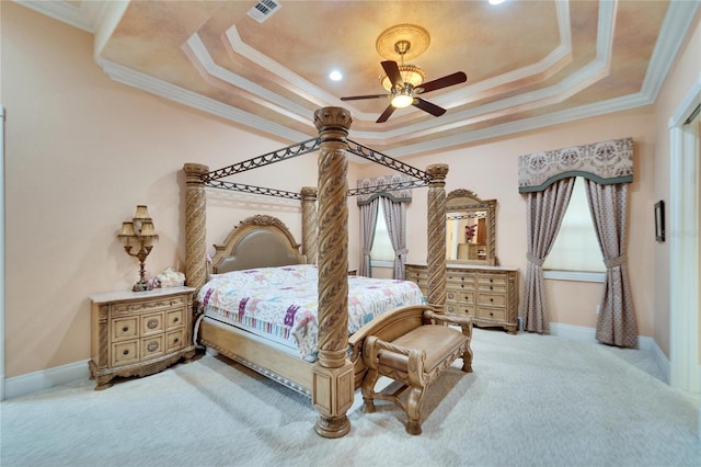 carpeted bedroom featuring ceiling fan, ornamental molding, and a raised ceiling