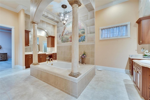 bathroom featuring vanity, crown molding, decorative columns, and a relaxing tiled tub