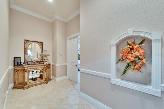 foyer with ornamental molding and light tile patterned floors