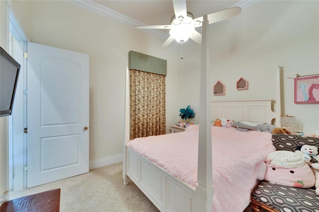 bedroom featuring ornamental molding, light colored carpet, and ceiling fan