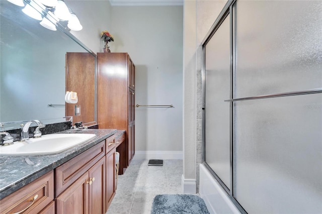 bathroom featuring enclosed tub / shower combo, vanity, and tile patterned floors