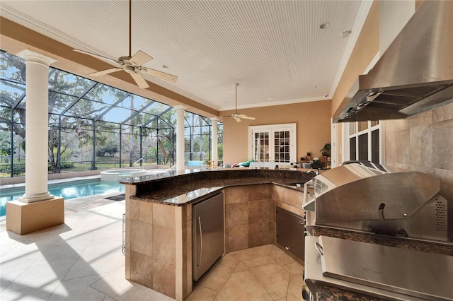 view of patio / terrace featuring exterior bar, area for grilling, a pool with hot tub, ceiling fan, and grilling area