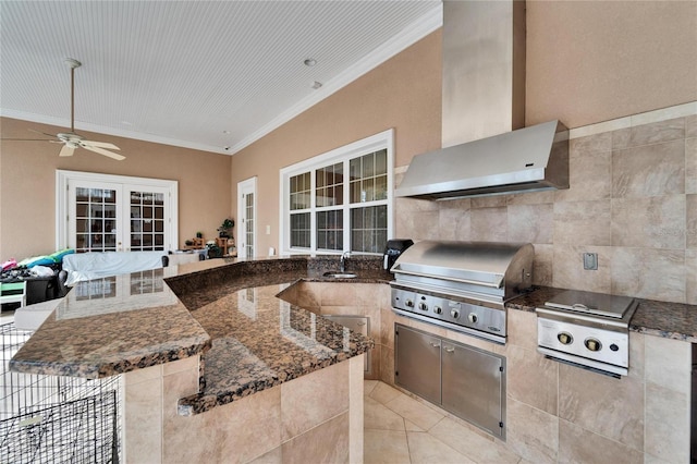 exterior space featuring sink, ceiling fan, a grill, french doors, and exterior kitchen