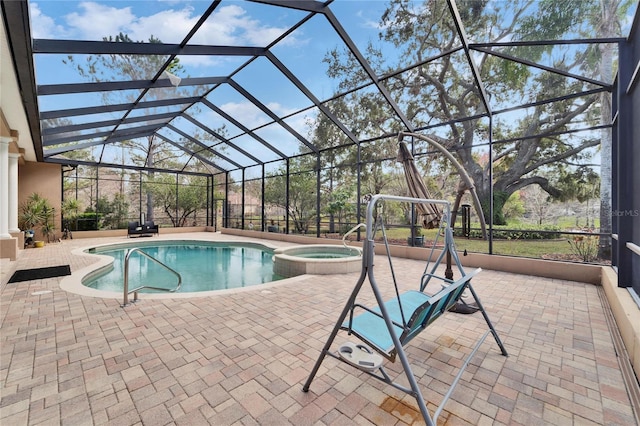 view of swimming pool with a lanai, a patio area, and an in ground hot tub