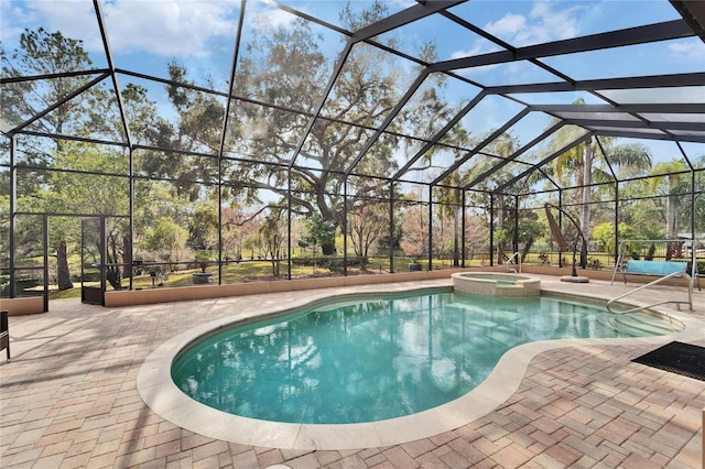 view of swimming pool with an in ground hot tub, a patio, and glass enclosure