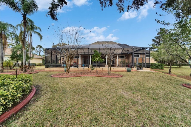 rear view of property with a lanai and a yard