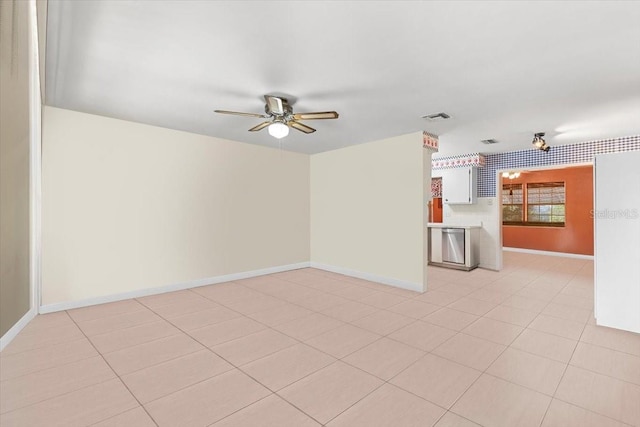 empty room with light tile patterned flooring and ceiling fan