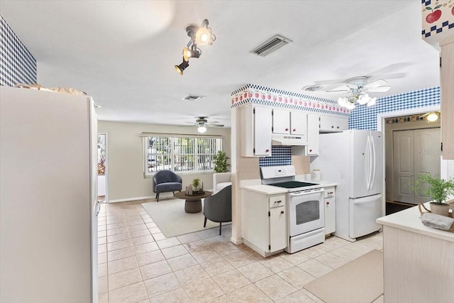 kitchen featuring ceiling fan, light tile patterned flooring, white cabinets, and white appliances