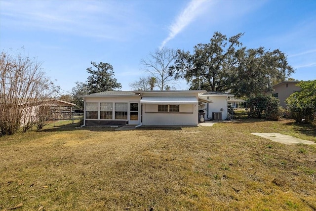 back of property featuring a yard and cooling unit