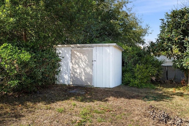 view of outbuilding with a lawn