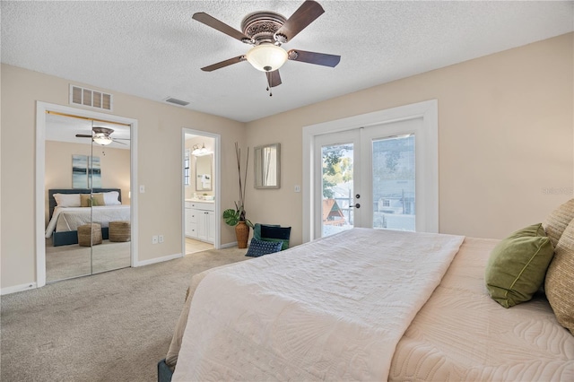 bedroom with access to outside, light colored carpet, french doors, and a textured ceiling