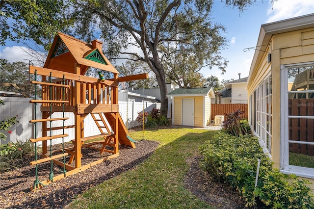 view of yard featuring a playground and a shed