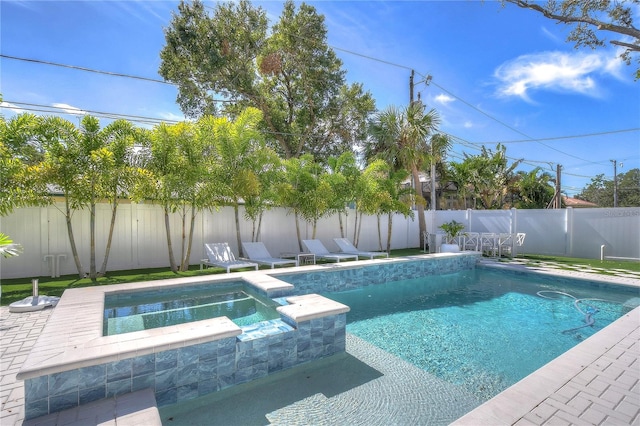 view of swimming pool with a pool with connected hot tub and a fenced backyard