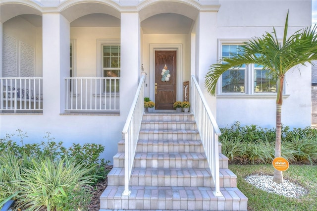 doorway to property with stucco siding