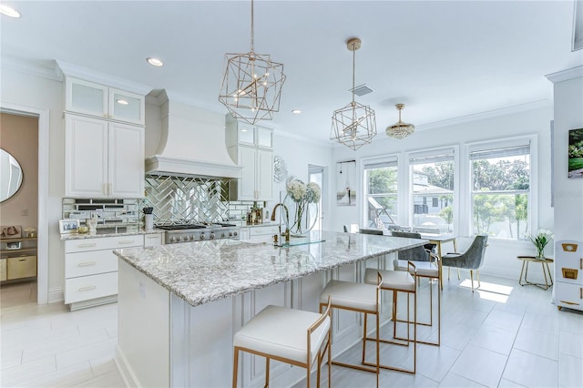 kitchen featuring ornamental molding, tasteful backsplash, stove, and custom range hood