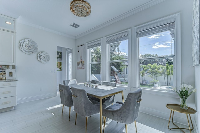 dining space with ornamental molding, visible vents, and baseboards