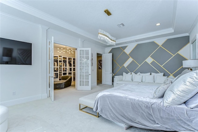 carpeted bedroom featuring french doors, crown molding, visible vents, an accent wall, and wallpapered walls